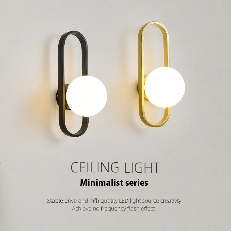 Minimalist wall lamp with glass shade and iron body in black finish mounted on wall