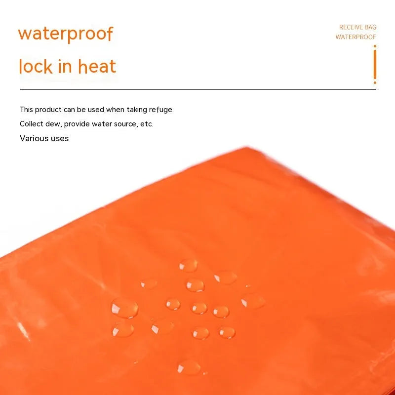 Orange portable disaster relief tent kit with sleeping bag and emergency blanket laid out.
