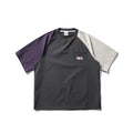 Dark grey loose-fit t-shirt with contrast colour raglan short sleeves on a hanger.