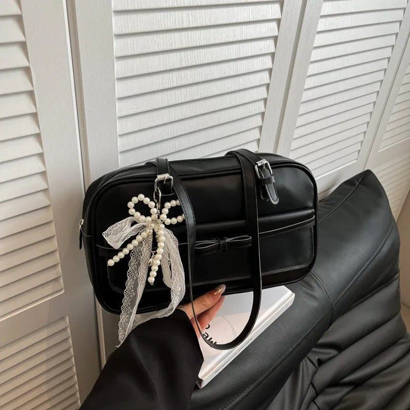 Women's black PU leather single shoulder flap bag with horizontal square shape and bow detail