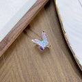Close-up of an adjustable copper ring with an insect motif and an irregular dripping oil finish.