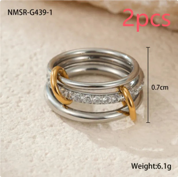 Stacked gold plated stainless steel ring set with exaggerated design on hand