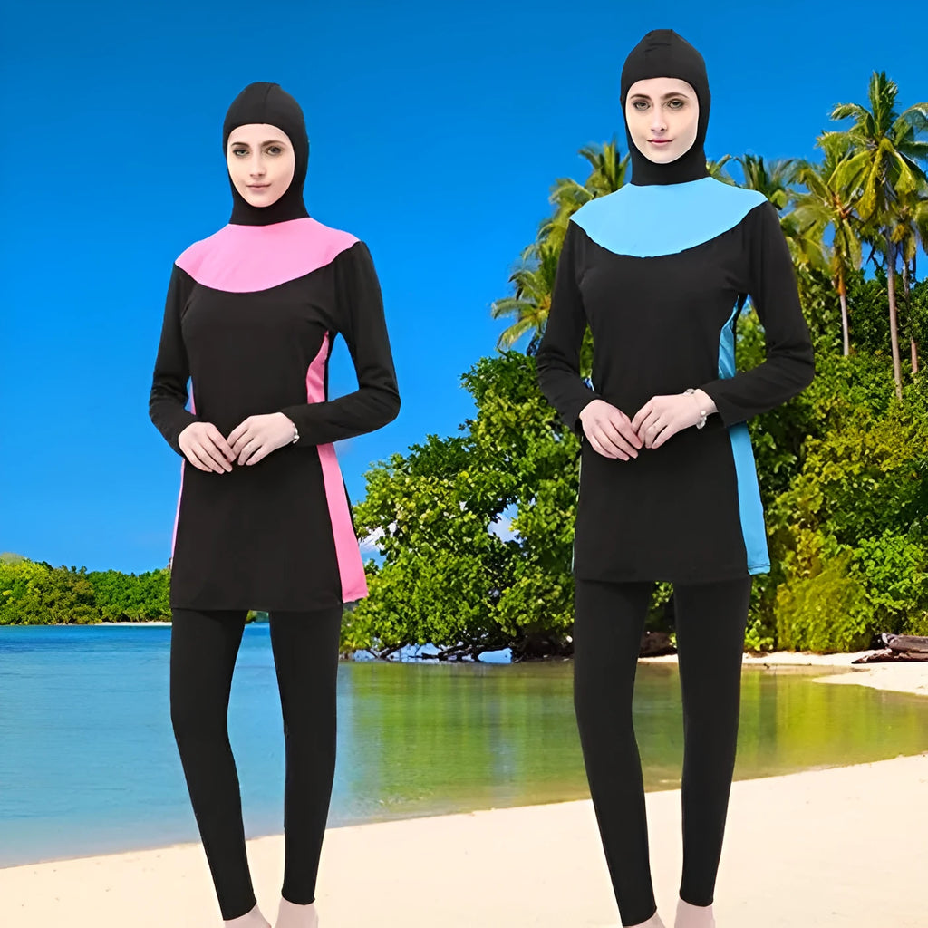 Women's black long sleeve hooded swimsuit with separate pants, shown on a model.