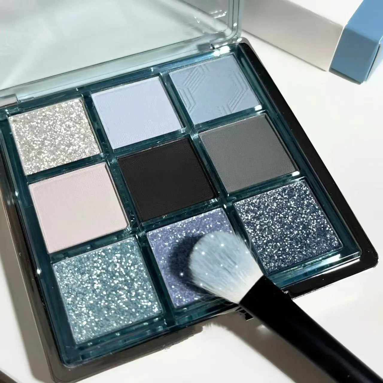 MUGELEEN nine-colour eye shadow palette 08 showing low saturation ice blue and smoked tone shades