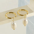 Gold geometric drop earrings for women with a pearl detail on a stainless steel base.