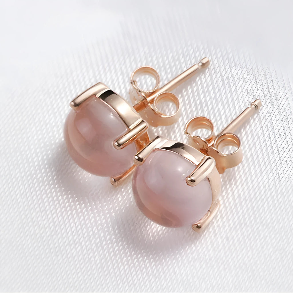 Rose gold drop shape stud earrings with synthetic ross quartz crystal inlay detail