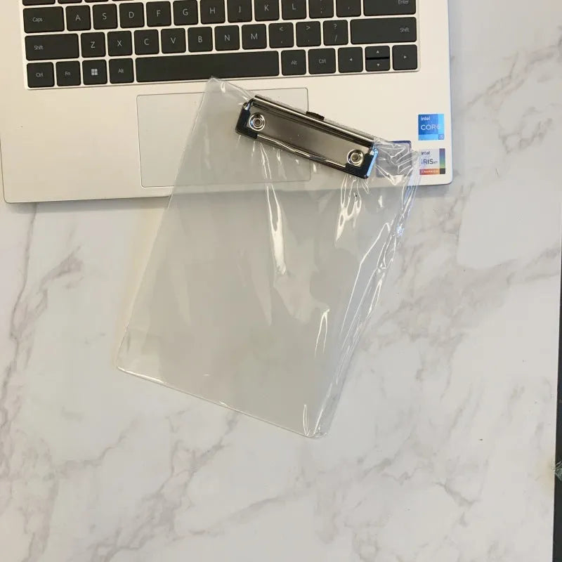 Transparent A4 writing board pad with metal clip holding paper, shown in blue colour variant.