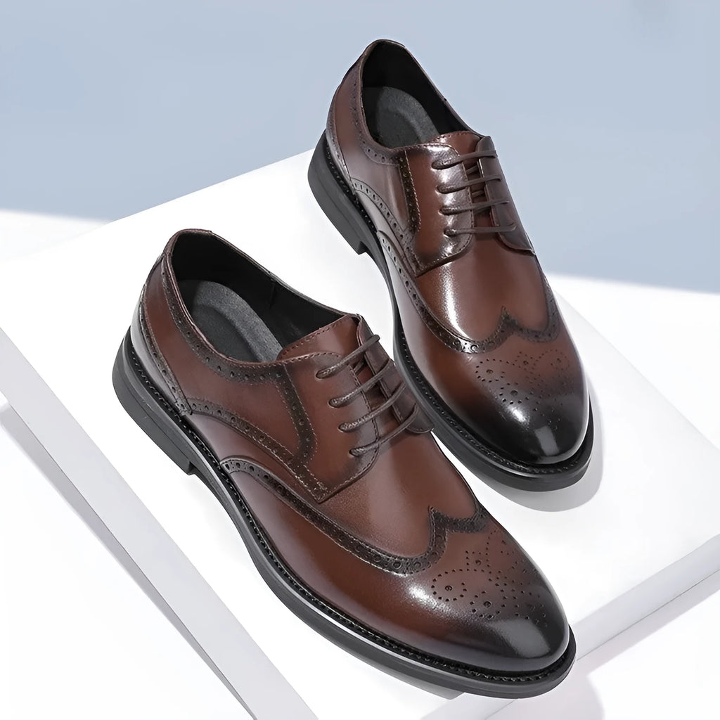 Men's classic black and brown brogue leather shoes with wingtip design on a white background.