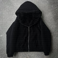 A black casual loose coat with long sleeves on a hanger, cardigan style.