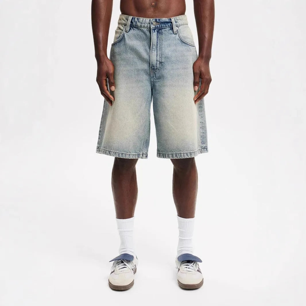 Men's loose straight-leg light blue cotton jeans on a white background.