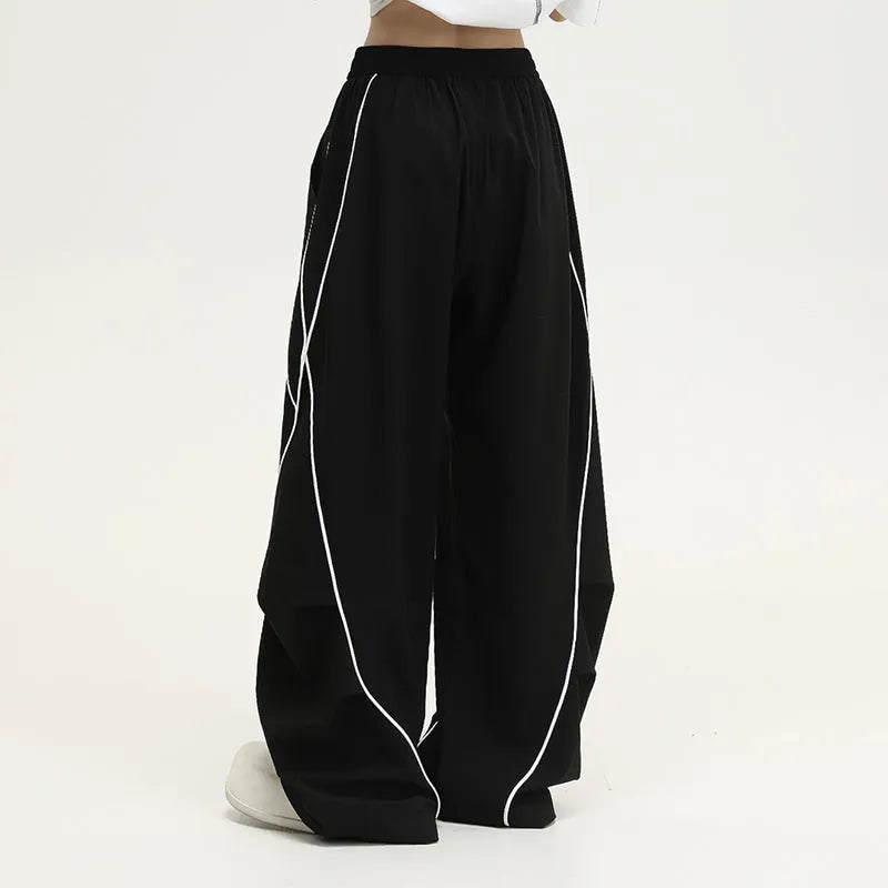 Black pleated hip hop trousers with wide-leg design and stripe pattern