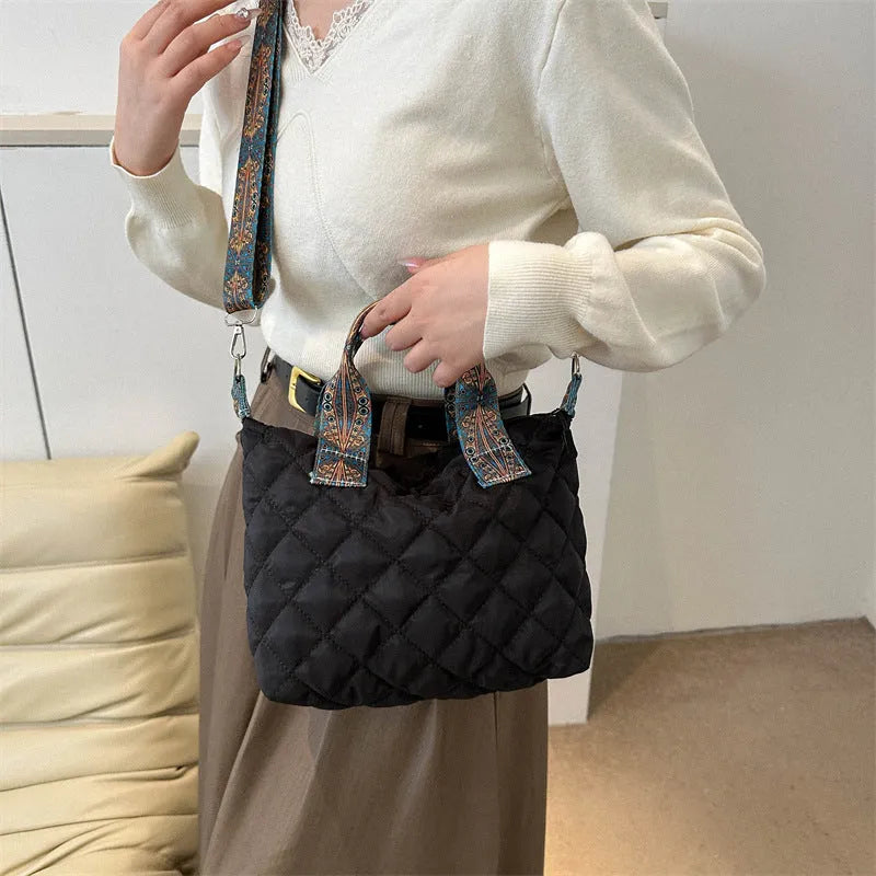 Soft horizontal square Oxford cloth shoulder messenger bag in green with embroidery detail and a single strap.