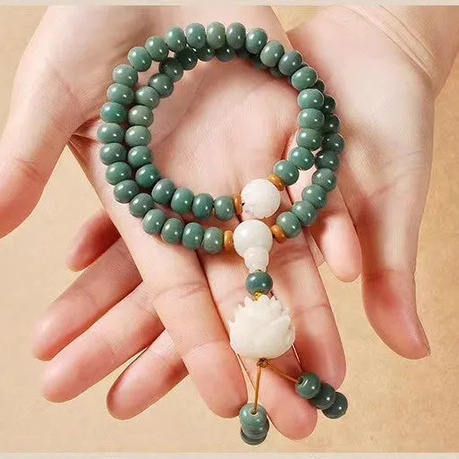Unisex natural Bodhi seed bracelet with white jade beads and green sandalwood on a white background.