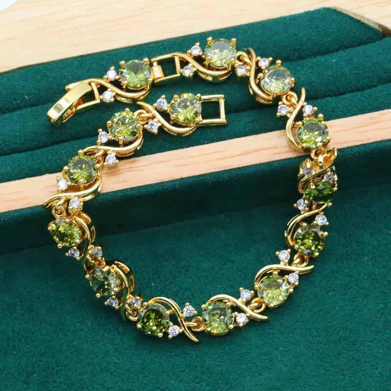 Olive green and red women's jewellery set with zircon stones, snake bone chain necklace, earrings, and ring.