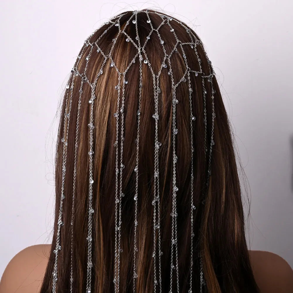 Gold rhinestone and mesh tassel headband on white background