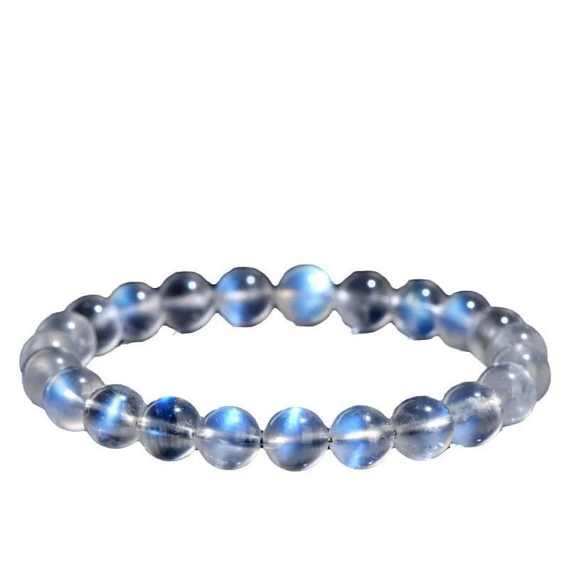 Natural cream body crystal bracelet with spherical beads on a wrist, showing minimalist unisex design.