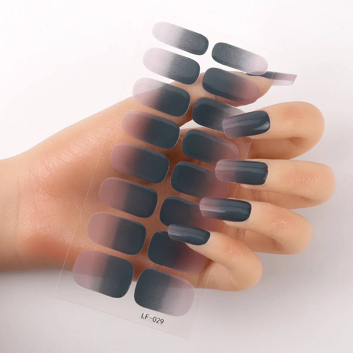 Set of 16 solid colour nail art stickers showing floral, geometric, and pattern designs for manicure application