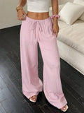 Women's wide-leg trousers with lace-up waist detail in black and pink colour options