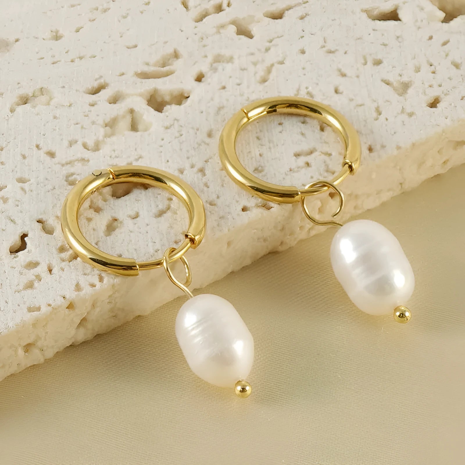 Gold geometric drop earrings for women with a pearl detail on a stainless steel base.