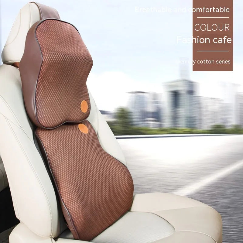Black and brown memory foam car headrest and lumbar support pillows on a car seat.