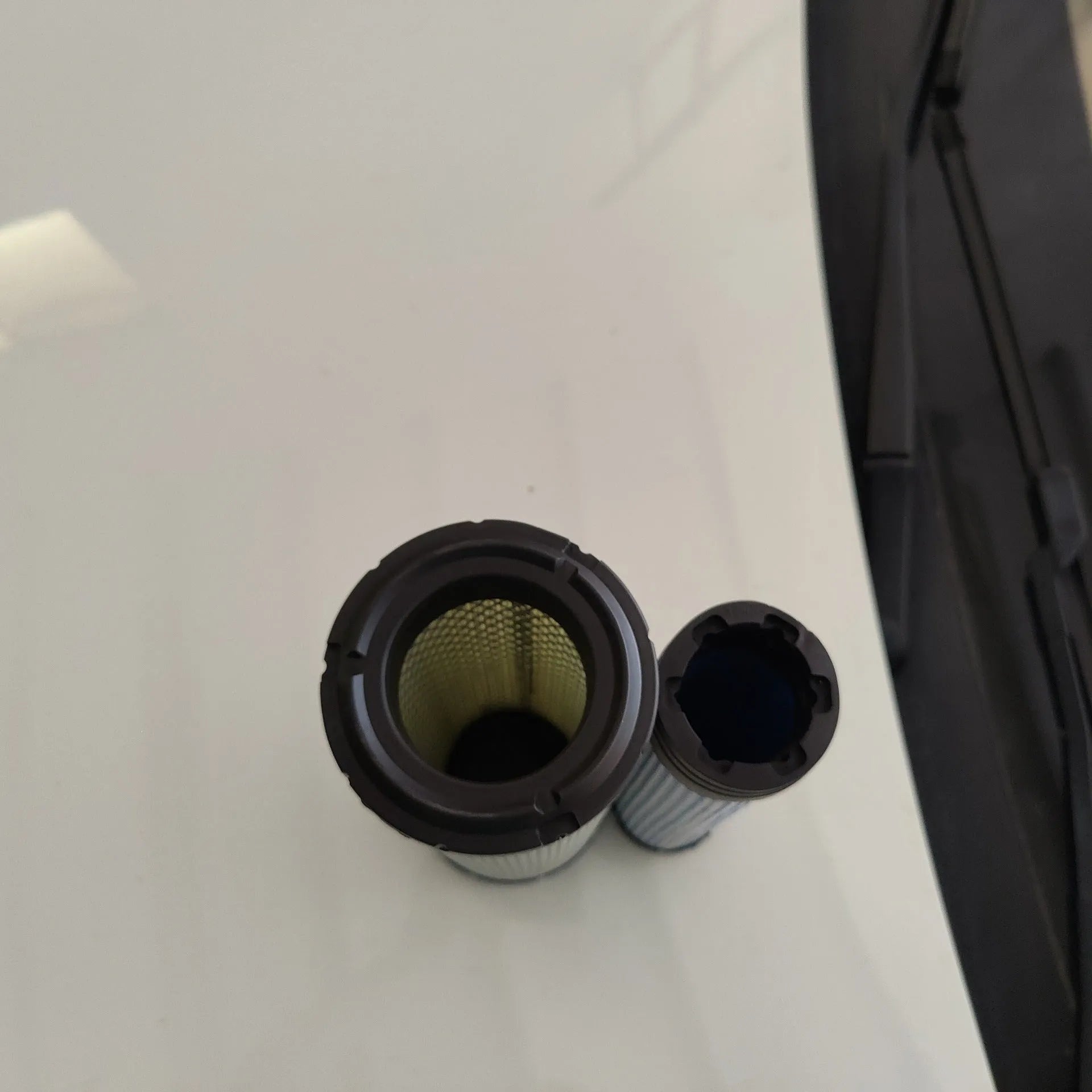 Large cylindrical Donaldson 1027 engine air filter with straight head and elbow connector