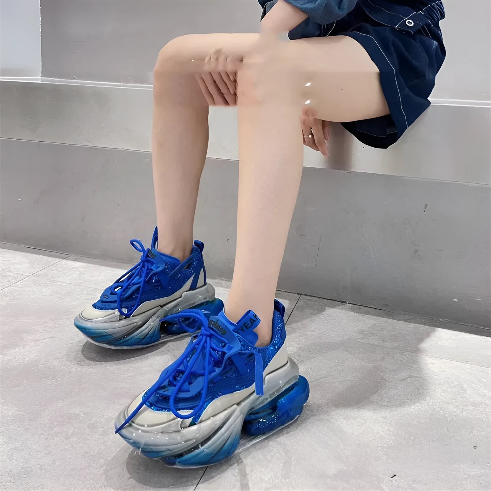 Women's green leather sports shoes with a thick clear jelly sole and white cross-tie laces.