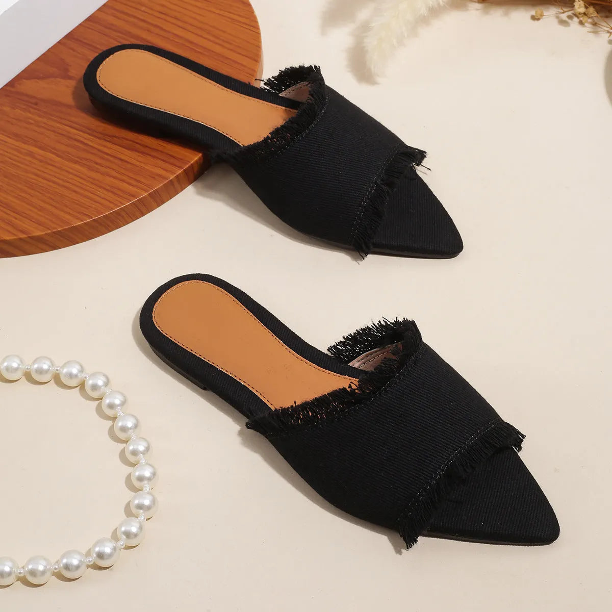 Women's denim casual flat slippers with a tassel detail in multiple colour options.