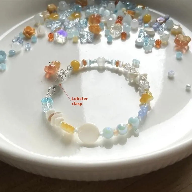 Orange diamond-shaped women's bracelet with round details on a mixed material and alloy band.