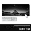 Oversized natural rubber gaming desk mat with graphical print, showing keyboard and mouse placement.