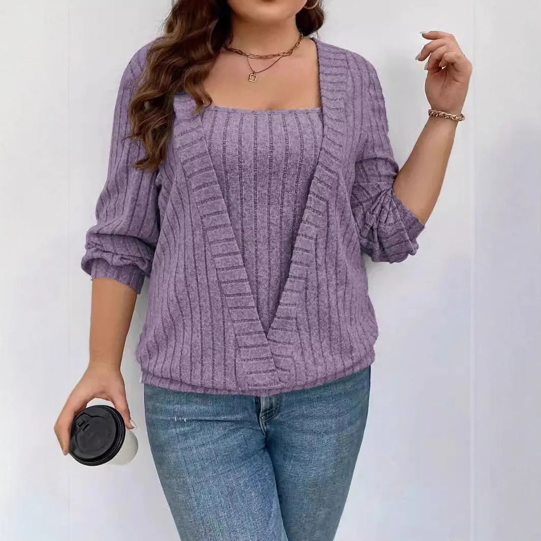 Women's solid colour ribbed V-neck false two-piece suit top with long sleeves on a hanger.