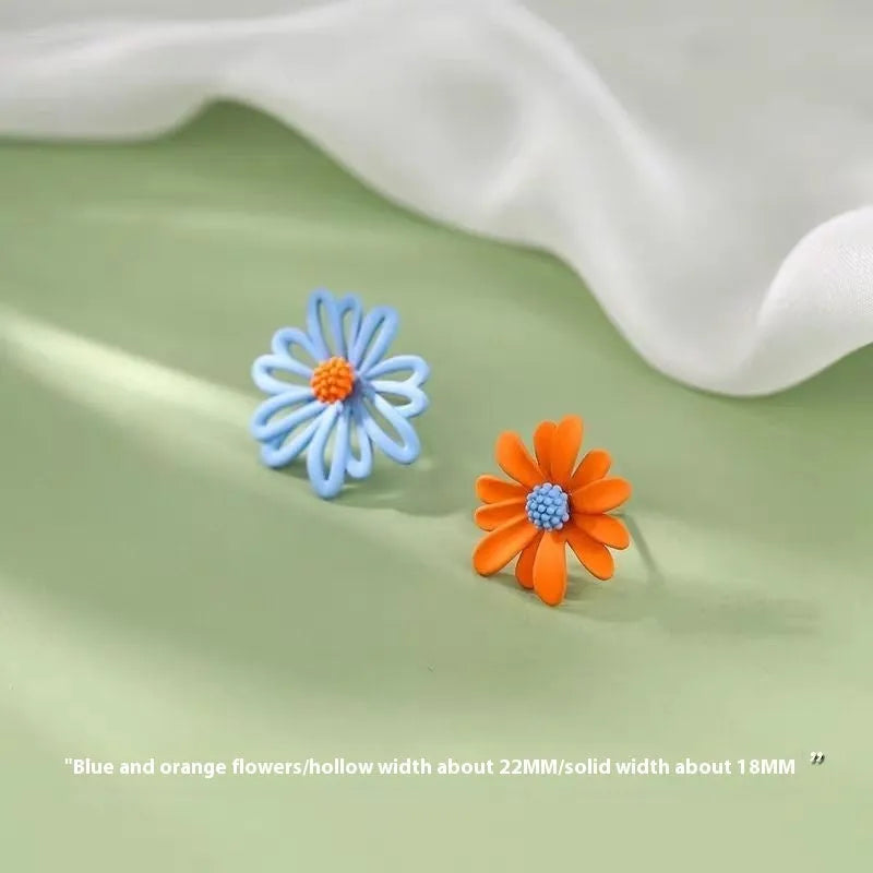 Cartoon style flower stud earrings made from alloy in blue and orange two-tone colours.