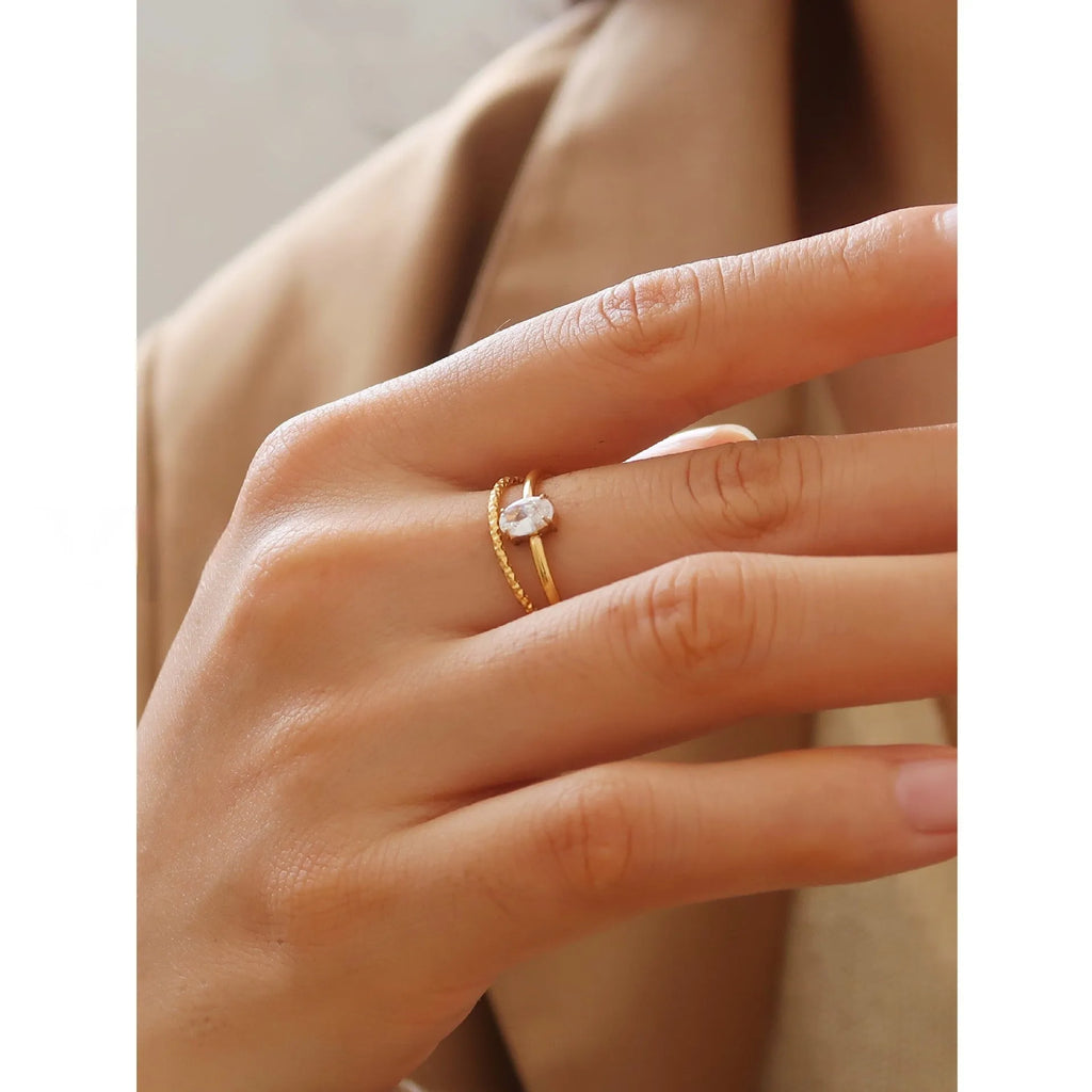 Golden stainless steel ring showing heart and oval love symbol designs with size options from 5 to 8