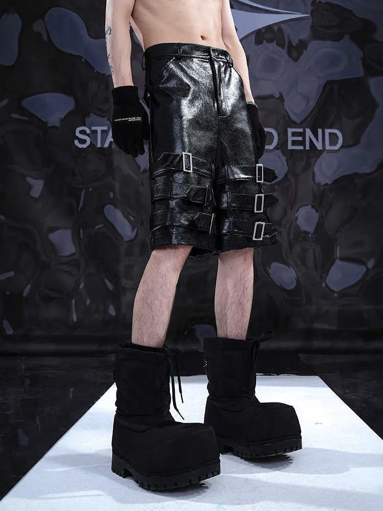 Men's black PU leather cropped shorts on a neutral background