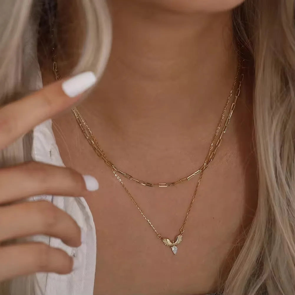 Close-up of an eagle pendant on a silver O-ring chain necklace, showing adjustable length.