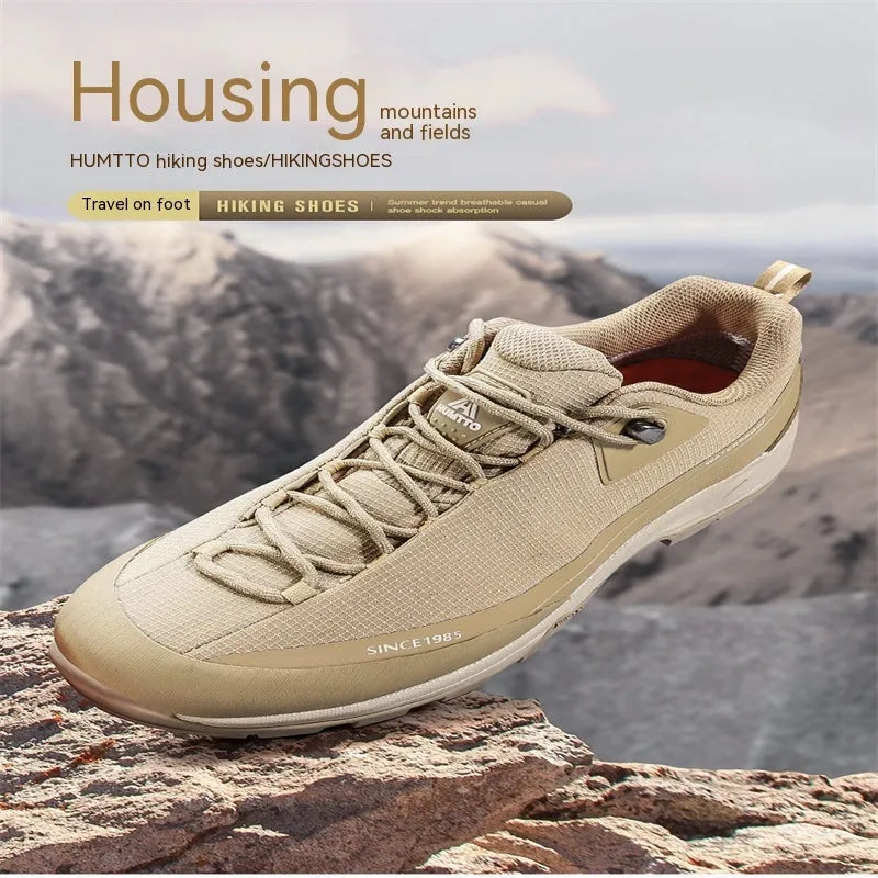 Men's low-top mountain climbing hiking boots with rubber outsole and lace-up front