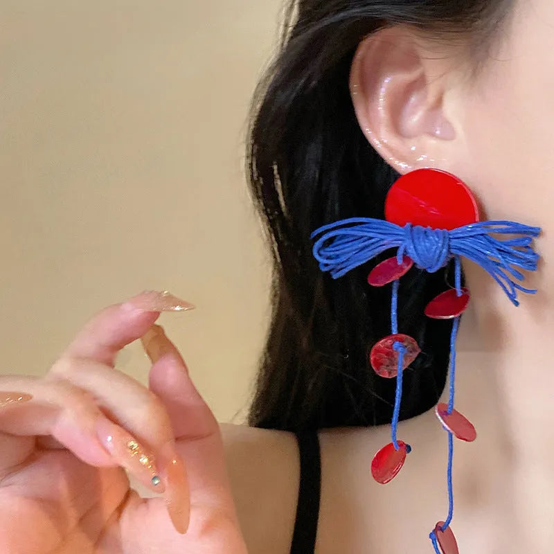 Women's geometric earrings with blue resin flower design on cloth material