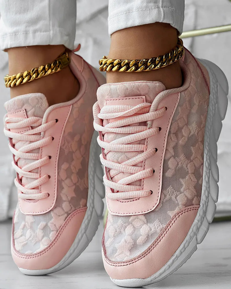Women's canvas running shoes in white, black, blue, and pink colours with flat heel design
