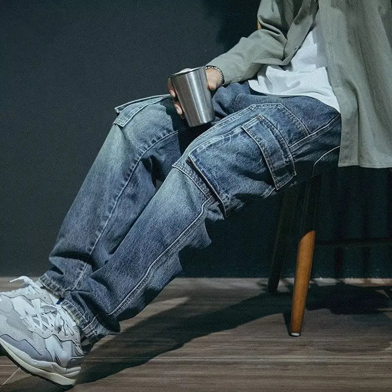 Blue men's loose straight-leg stretch denim trousers on a hanger