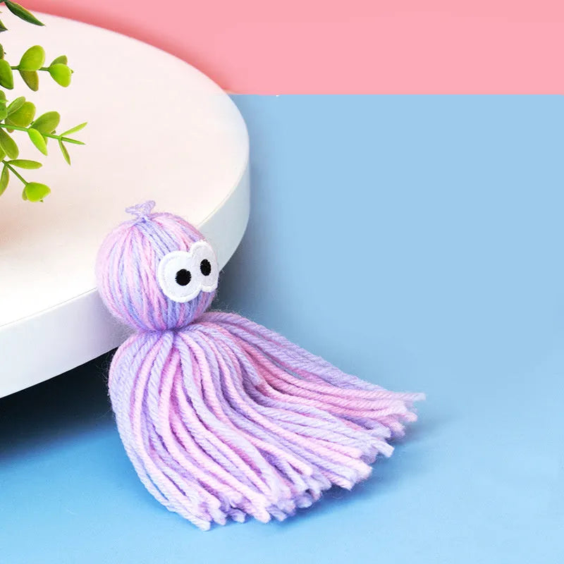 Bite-resistant wool ball cat toy with hanging loop in blue-grey colour option for teething relief