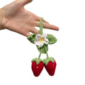 Handmade strawberry-shaped car pendant woven from cotton and hemp with natural colours