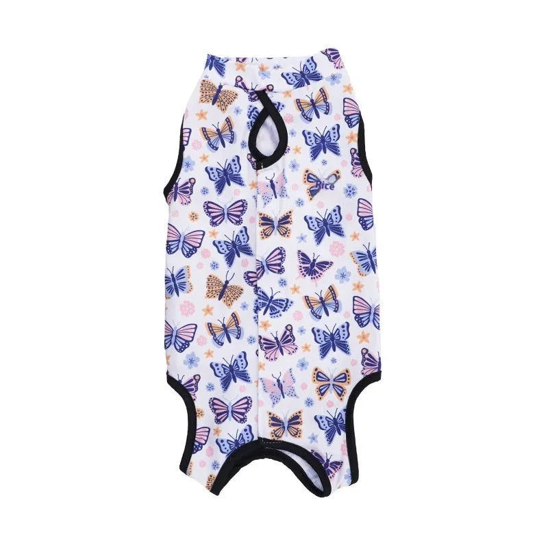 Cat wearing a blue printed post-operative recovery suit covering its torso, secured with Velcro fasteners.
