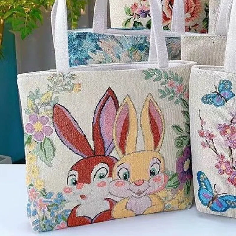 Handheld canvas bag with gold wire embroidery, shown in one of seven colour designs.