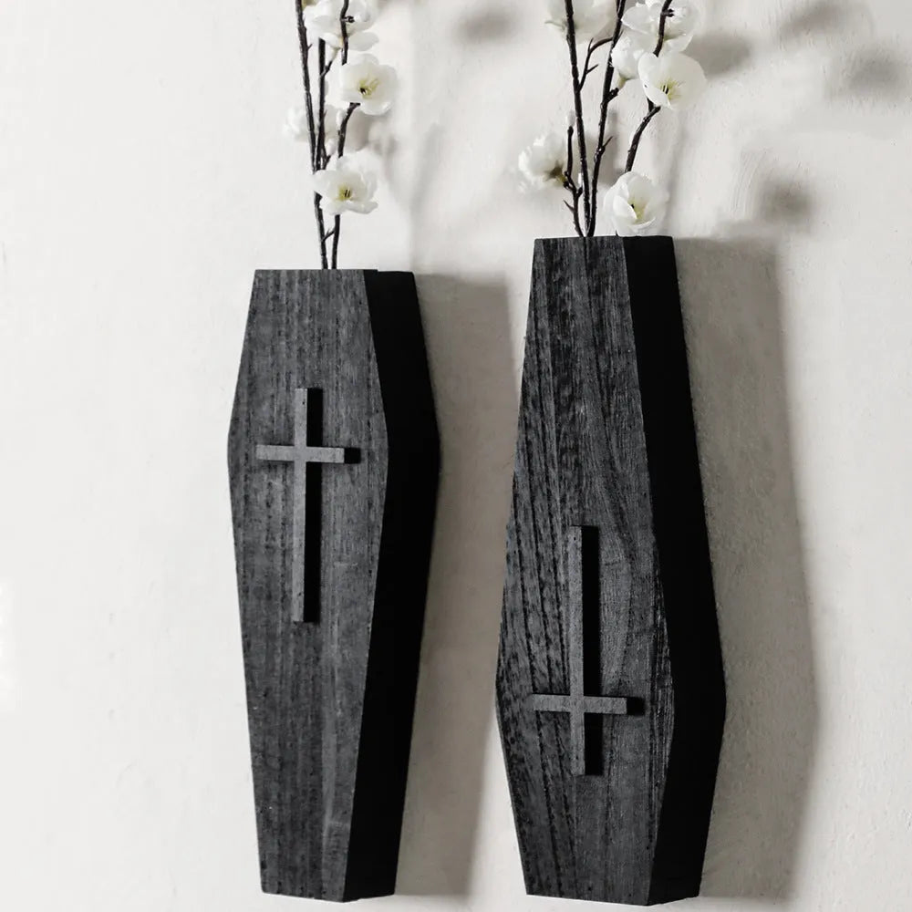 Black wooden cross-shaped wall shelf with a small ledge, measuring 27cm tall.