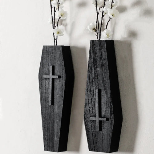 Black wooden cross-shaped wall shelf with a small ledge, measuring 27cm tall.
