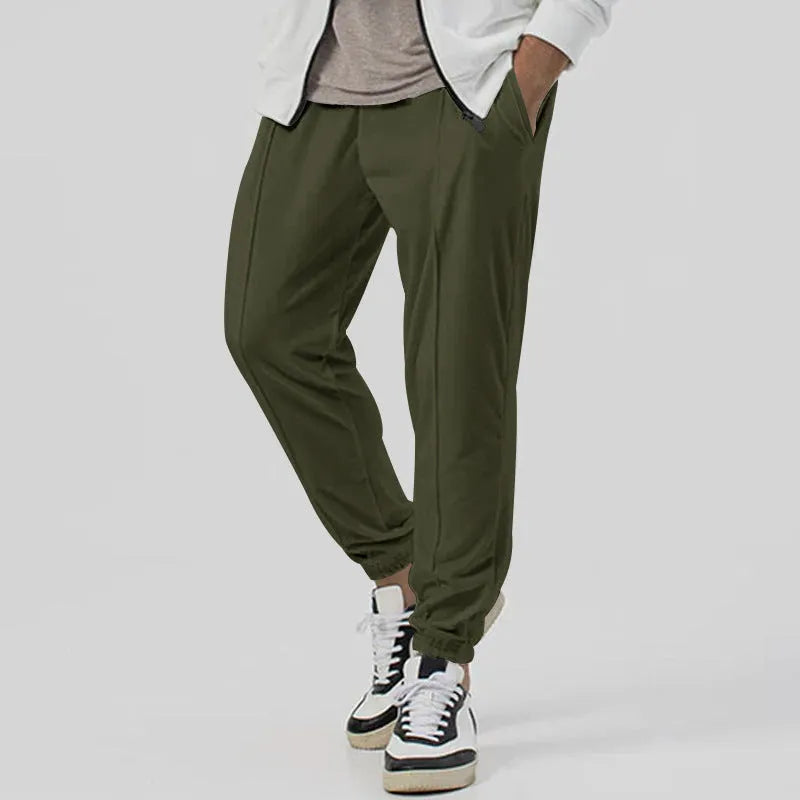 Men's loose tapered casual sweatpants in a grey cotton blend fabric with an elastic waistband.