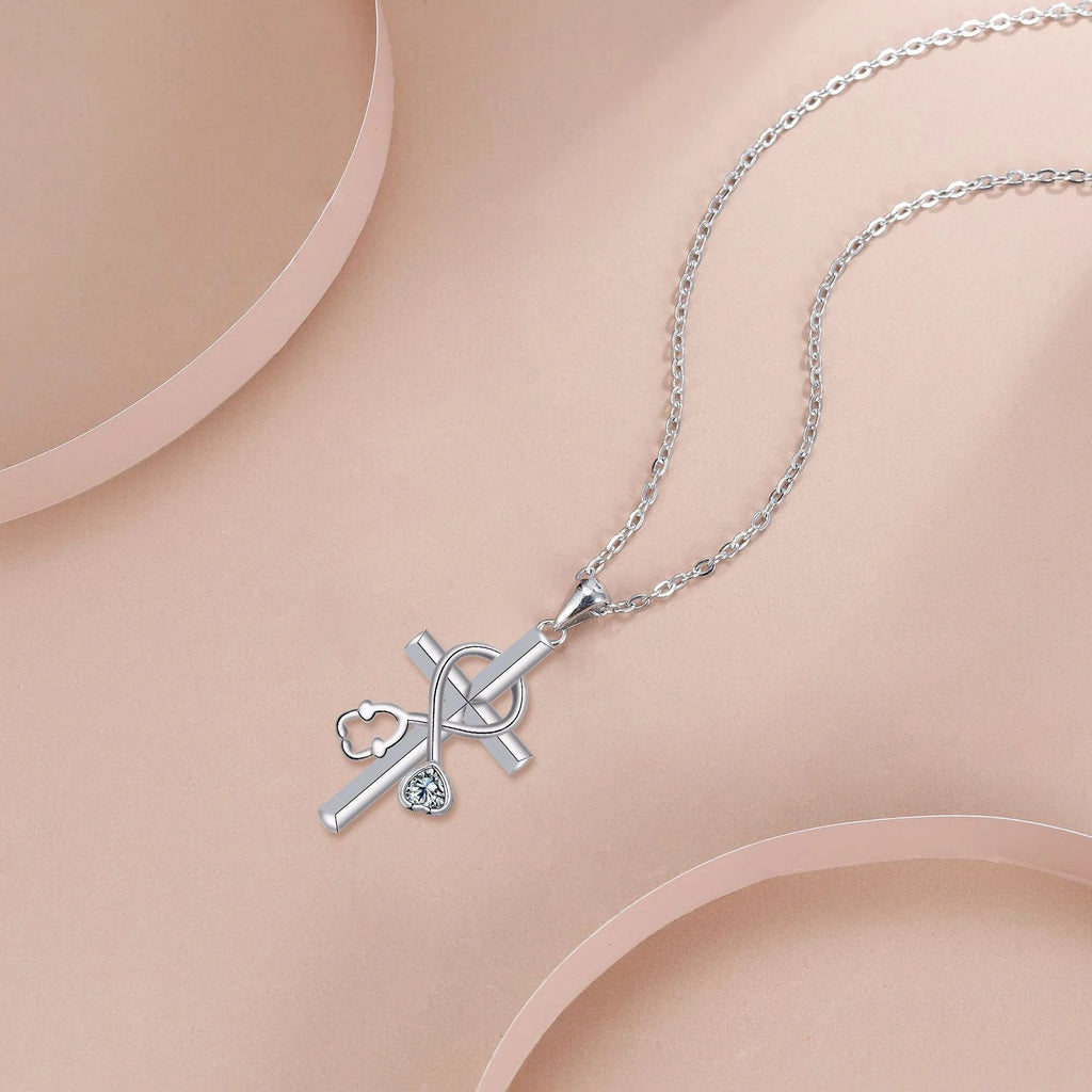 Women's copper cross stethoscope pendant necklace with electroplated finish on a cross chain.