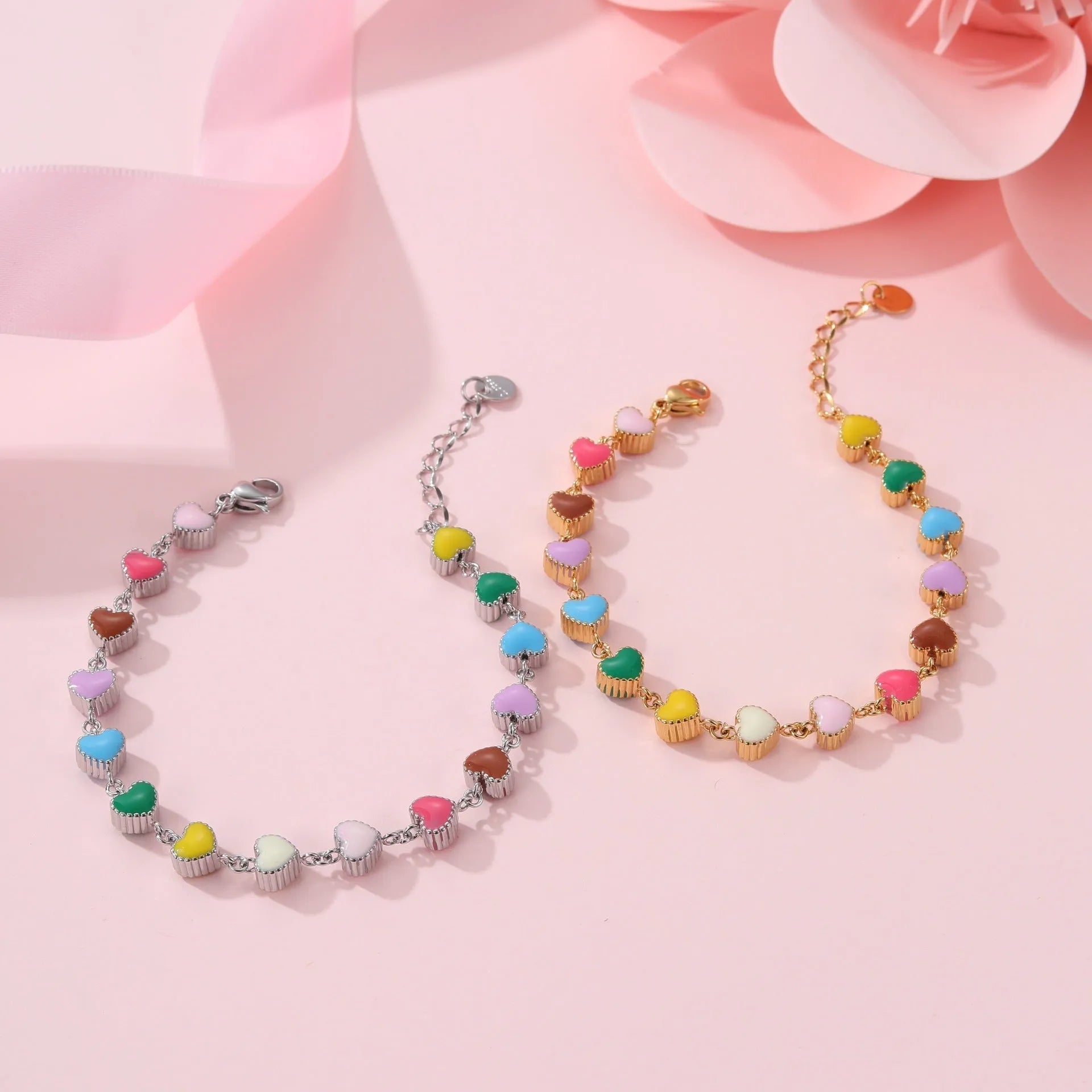 Close-up of a women's love heart-shaped bracelet in stainless steel with 18K gold plating.