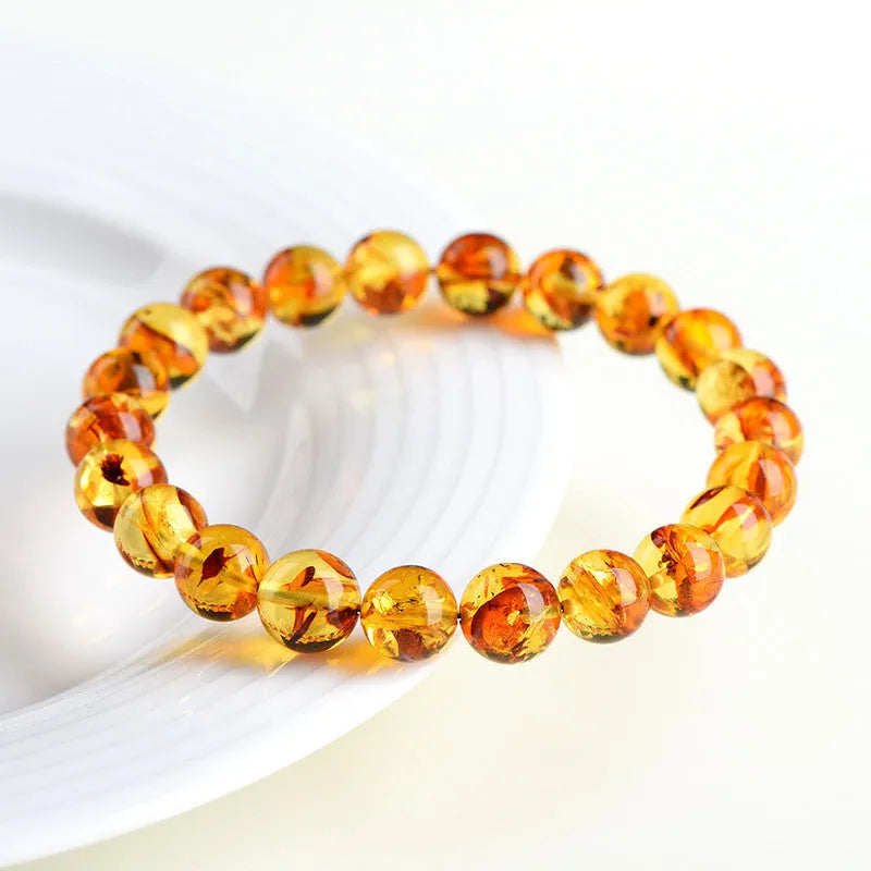Natural yellow piebald amber bracelet with geometric polished beads showing flower spot patterning