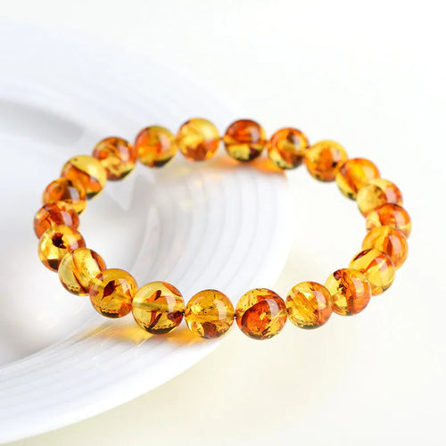Natural yellow piebald amber bracelet with geometric polished beads showing flower spot patterning