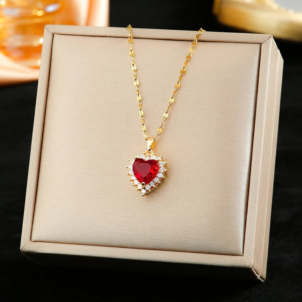 Gold-red titanium steel necklace and earrings set with heart-shaped flower pendant and gemstone detail.